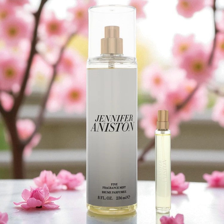 Jennifer Aniston Duo Fragrance Gift Set displayed in a blooming spring setting with soft pink flowers. Features the full-size 8 oz Body Mist and 0.5 oz Mini Perfume Spray, standing side by side on a clean surface. Ideal for showcasing luxury, freshness, and seasonal appeal.