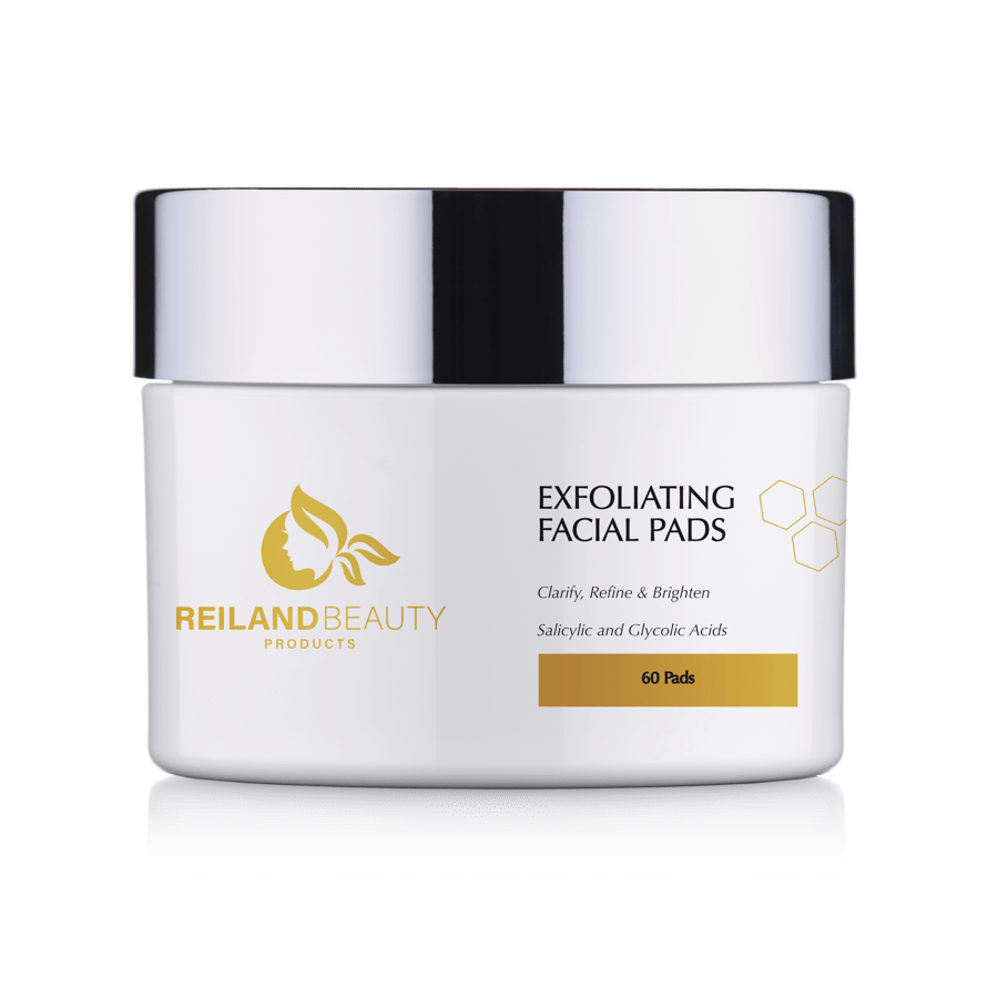 Product image of Reiland Beauty Exfoliating Facial Pads – 60-count jar featuring salicylic and glycolic acids for clarifying, refining, and brightening skin. Luxury skincare packaging in white and gold.