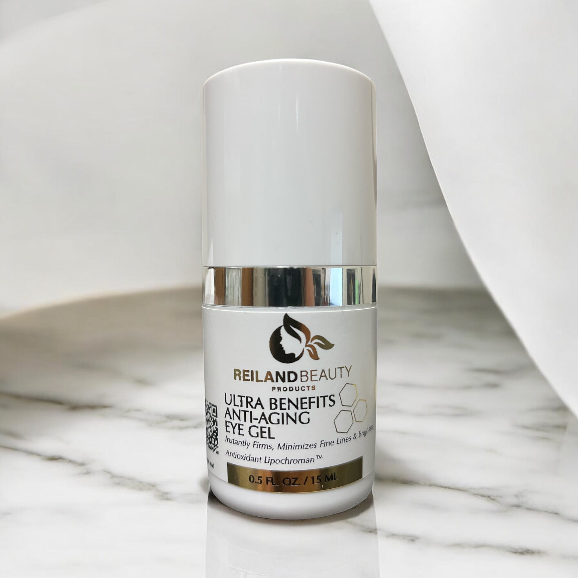 Reiland Ultra Benefit Anti-Aging Eye Gel placed on a luxurious marble surface with soft white draping, emphasizing elegance and clinical quality.