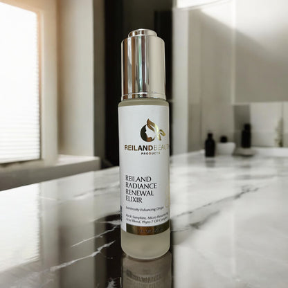 Reiland Radiance Renewal Elixir shown on a marble vanity counter with soft daylight filtering in, highlighting the spa-like elegance of this micro-resurfacing oil.