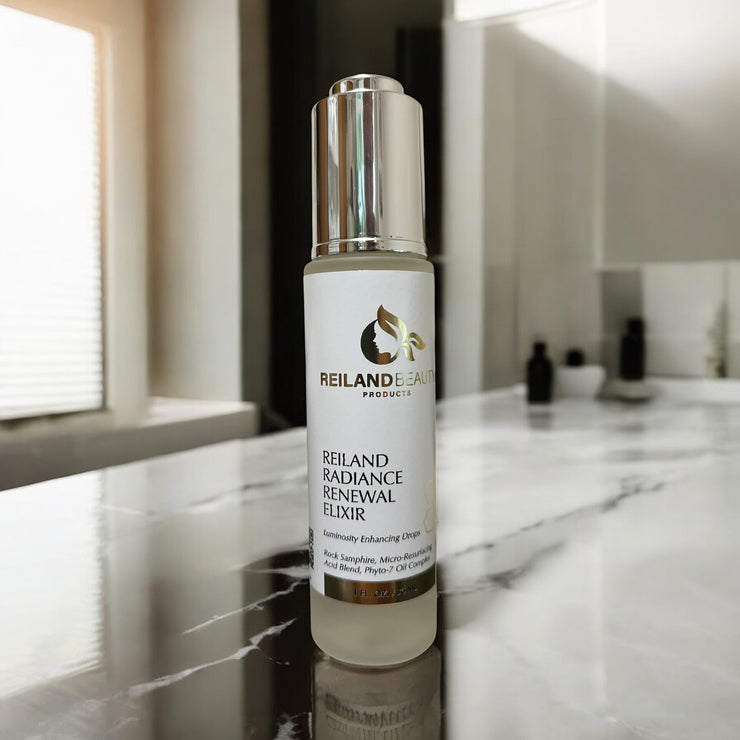 Reiland Radiance Renewal Elixir shown on a marble vanity counter with soft daylight filtering in, highlighting the spa-like elegance of this micro-resurfacing oil.