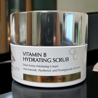 High-resolution close-up of Reiland Vitamin B Hydrating Scrub jar placed on a glossy surface with ambient light reflecting from the silver lid.