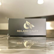 Luxury black packaging of Reiland Precision Brow Enhancer with gold logo